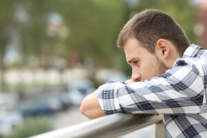 teen boy leaning on balcony