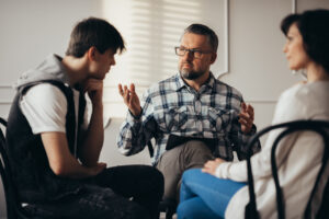 teen boy in family therapy with parents