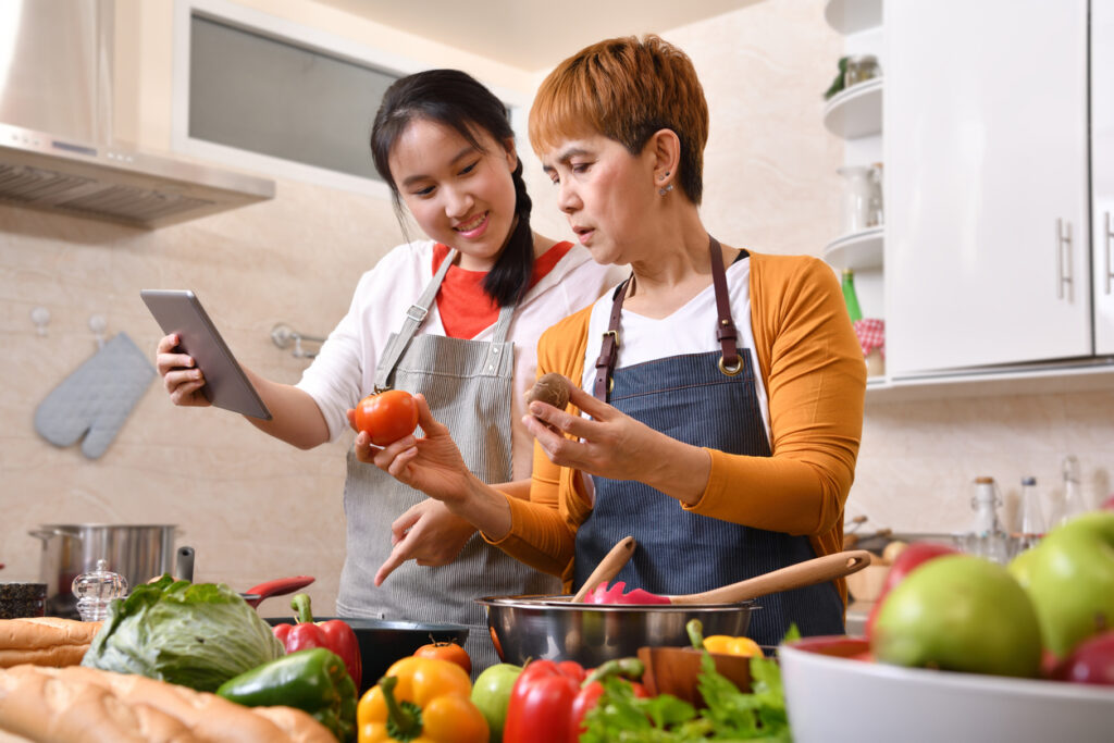 teen girl cooks with mom