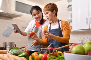 teen girl cooks with mom