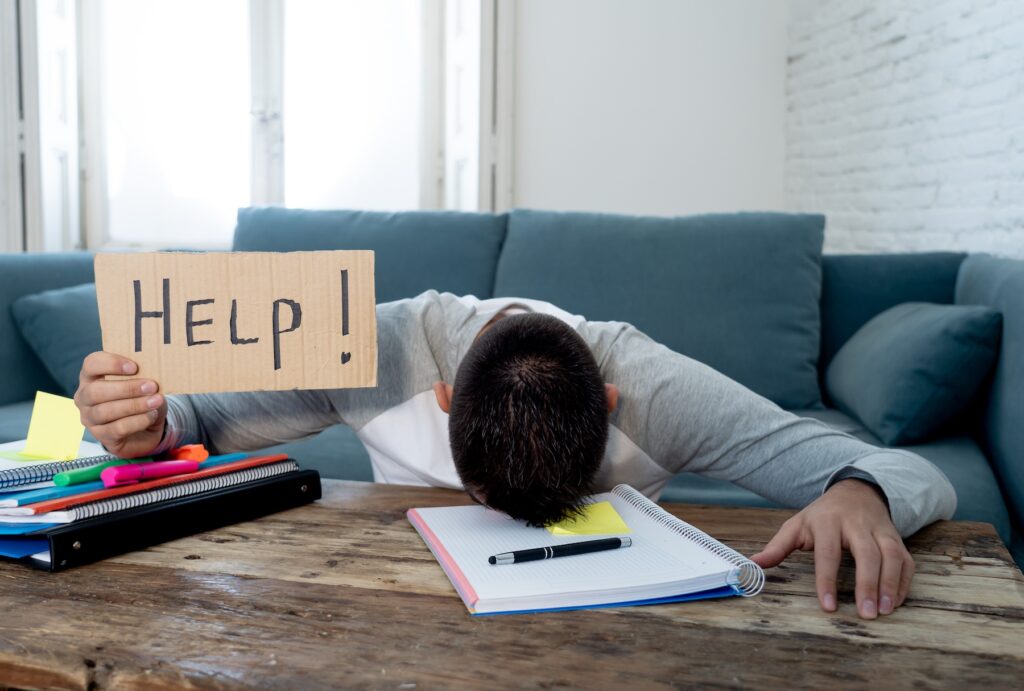 Teen holding up HELP sign