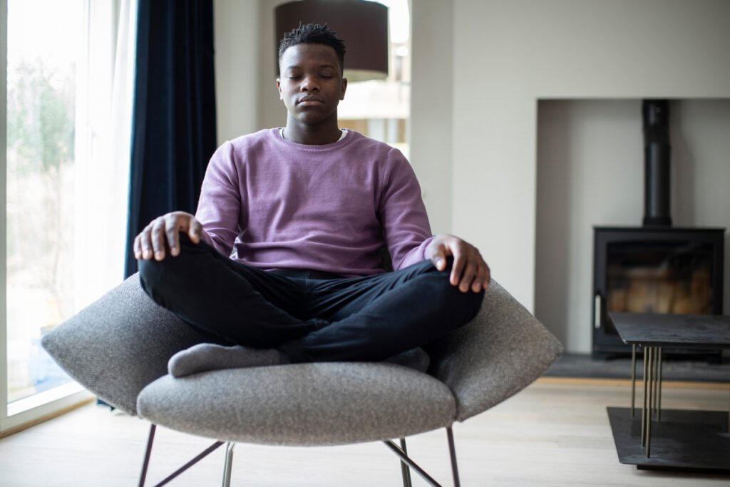 teen meditating in chair