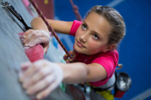 teen girl rock wall climbing