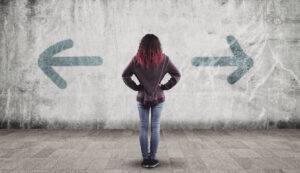 teen girl facing two arrows