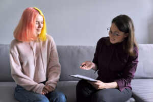 teen with therapist on couch