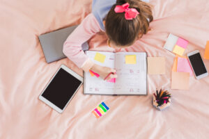 teen girl writing in calendar