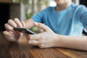 teenage boy surfing on phone