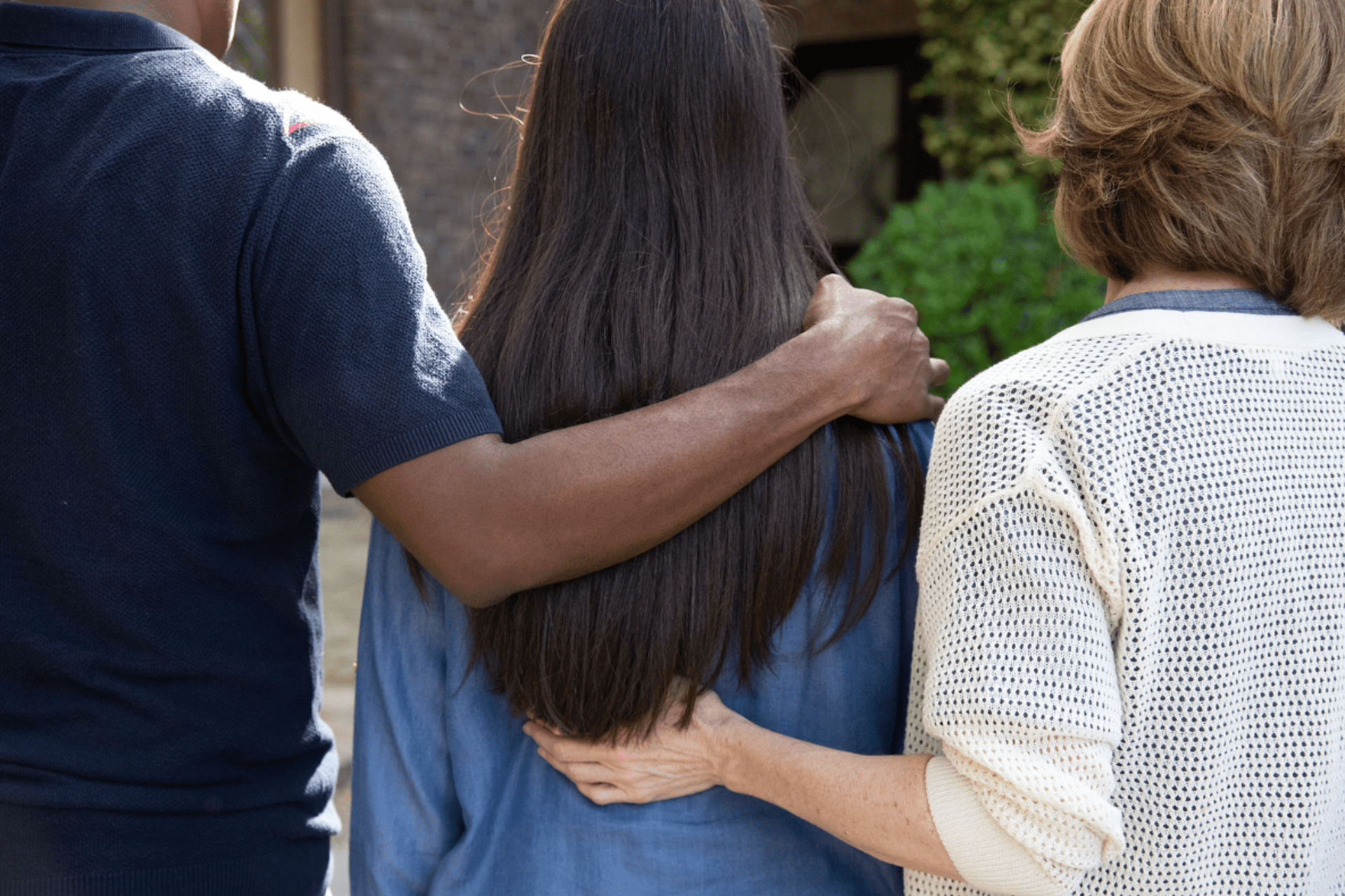 photo of parents hugging daughter goodbye